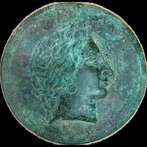 13. Χάλκινος δίσκος κατόπτρου. Φέρει στο κάλυμμα ανάγλυφη διακόσμηση γυναικείας κεφαλής σε κατατομή. Διάμετρος 15,20 εκ. Γύρω στα 270-260 π.Χ.
